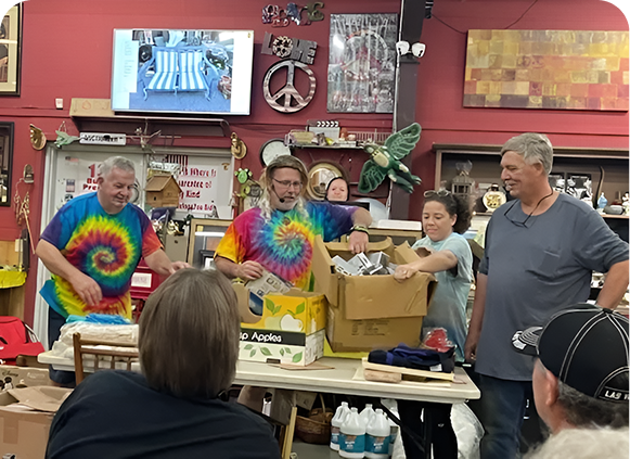 People sorting items at a busy auction.